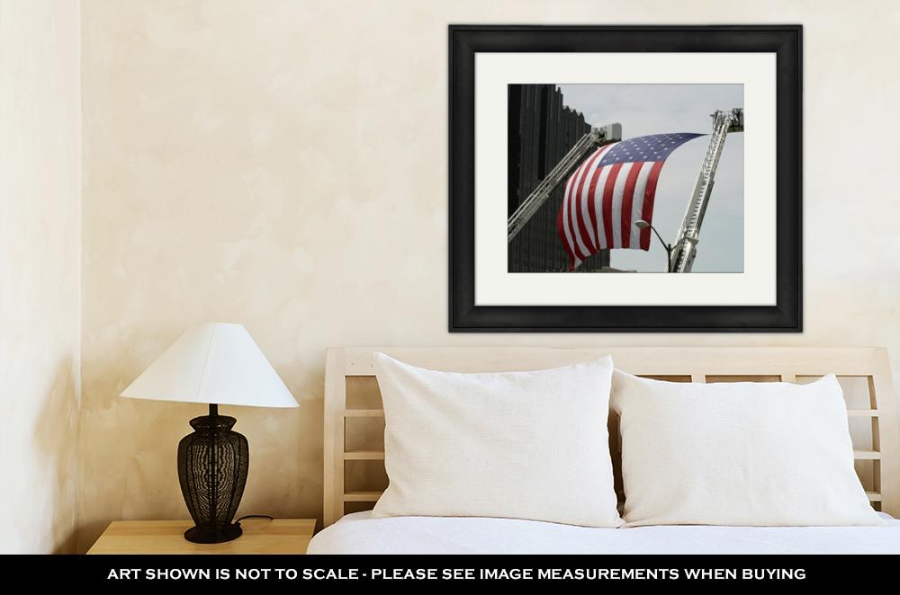 Framed Print, An Large American Flag Hanging Between Firefighter Truck Ladders - ultrawallart.com
